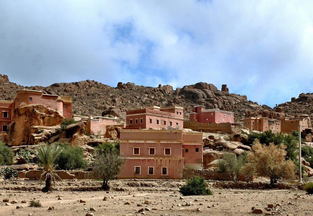 Scenic view of traditional Berber architecture in Tafraoute, Morocco, with rocky landscapes.