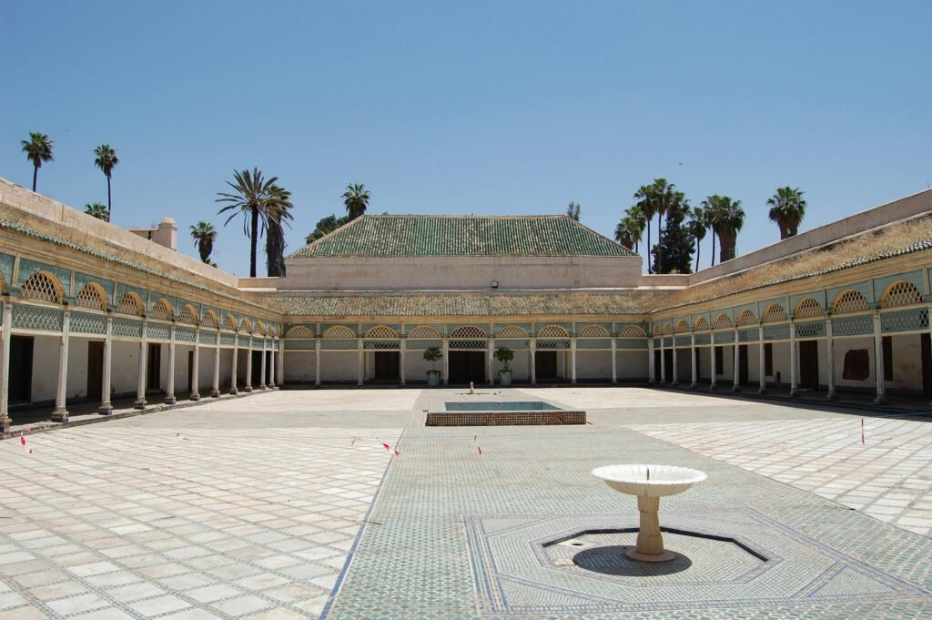 A serene courtyard with a fountain in a Moroccan palace, showcasing traditional architecture.